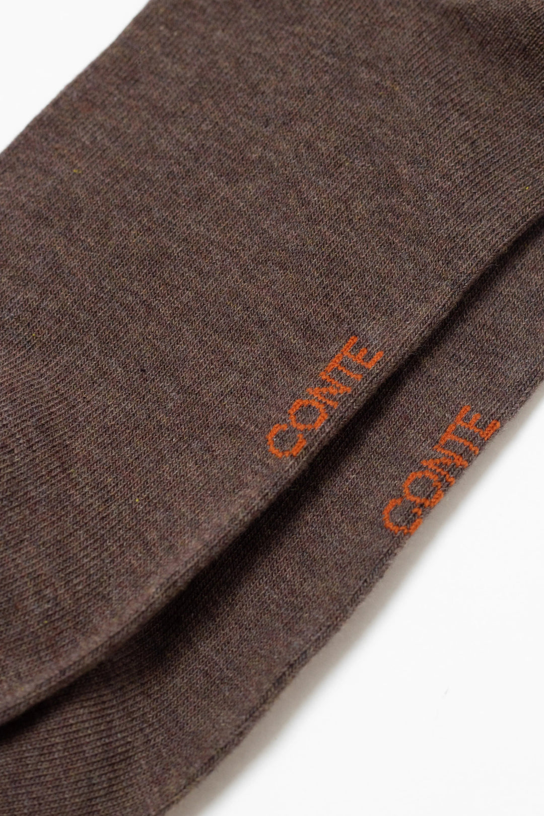 Brown fabric with 'Conte' branding on a white background  #color_brown