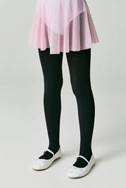 Person wearing black tights and white shoes on a plain background #color_nero-black