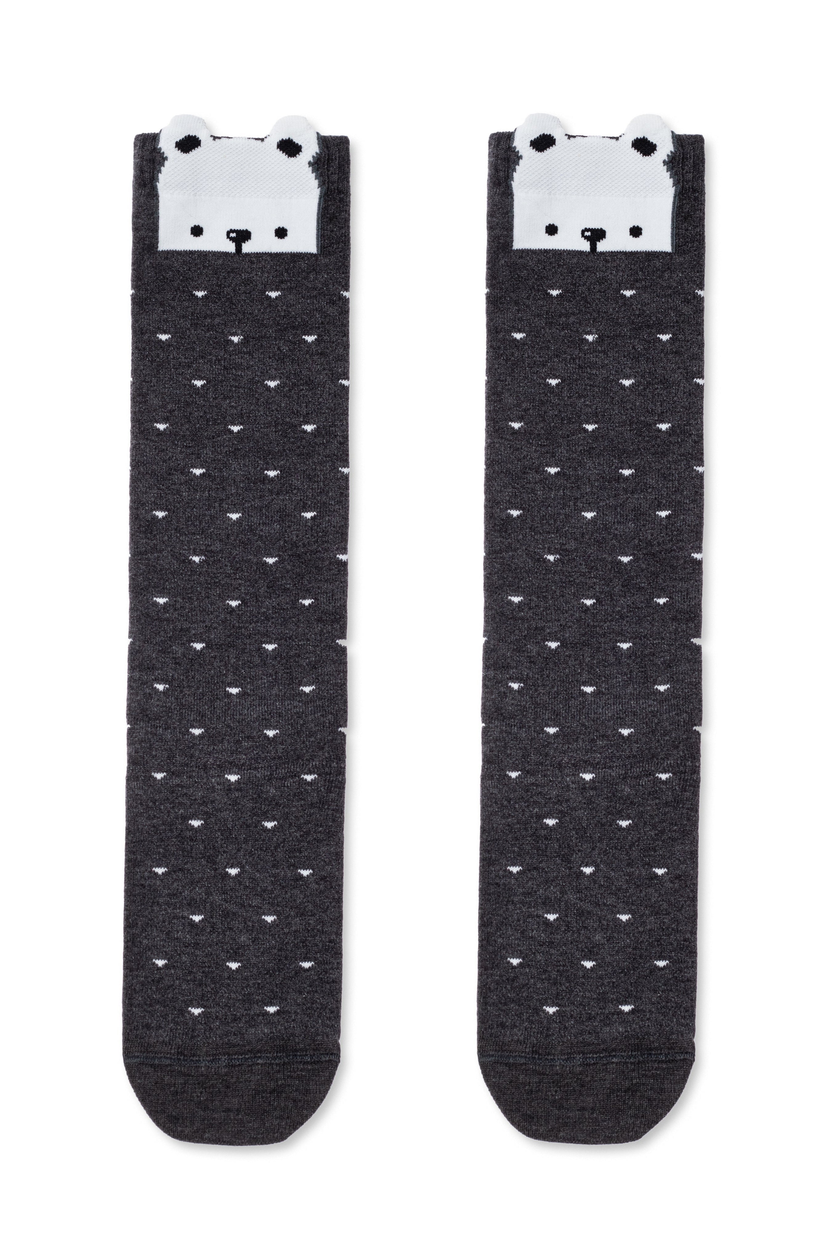 Pair of black socks with white bear faces on a white background