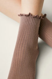 Brown ribbed knee-high socks with ruffled top on a light background #color_coffee