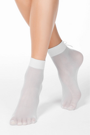 White fishnet socks worn by a person on a white background #color_bianco