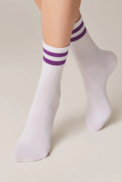 White socks with purple stripes worn by a person on a beige background #color_lilac