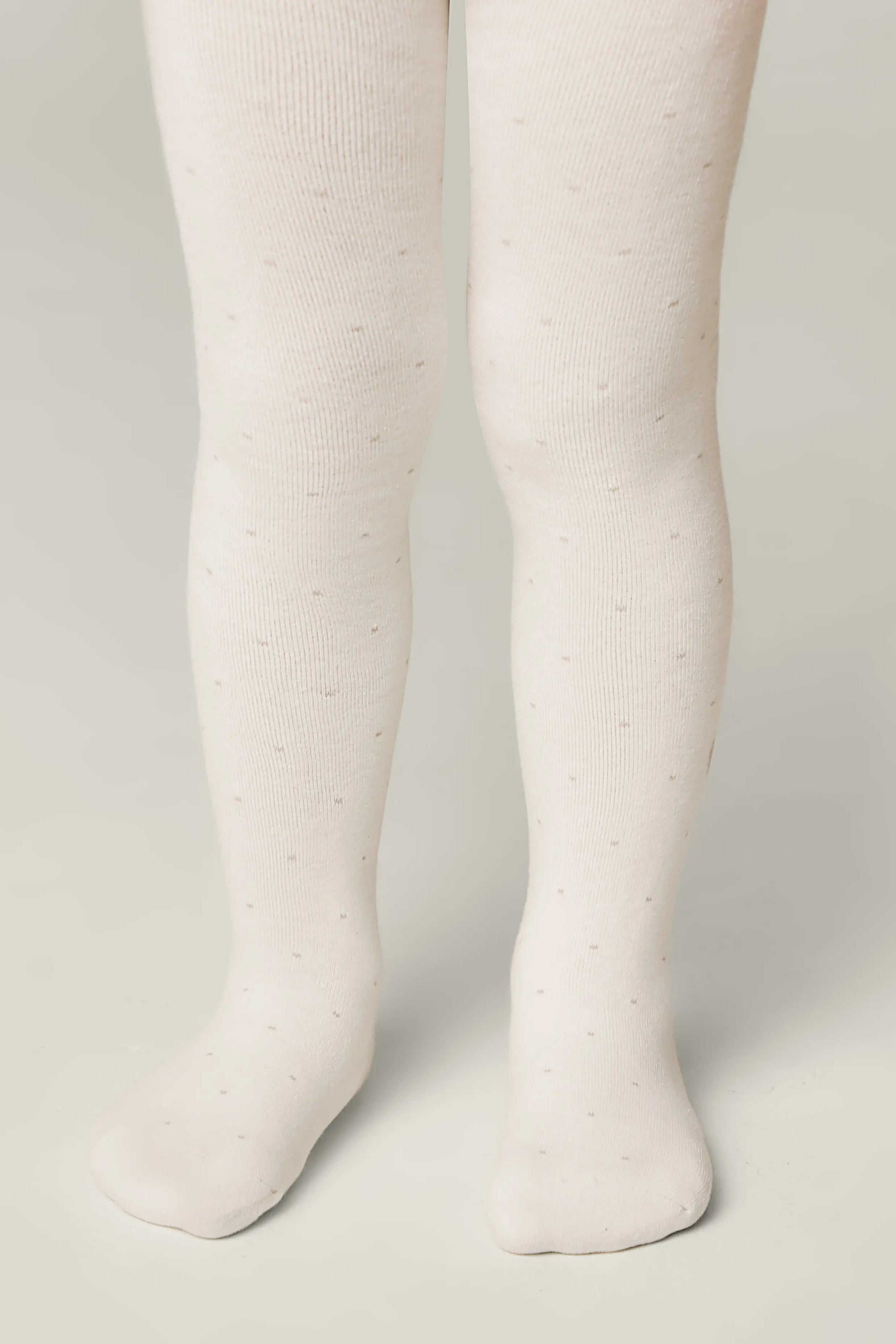 White tights worn by a person on a plain background #color_milky