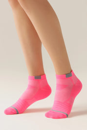 Neon pink socks worn with beige legs on a light background #color_pink