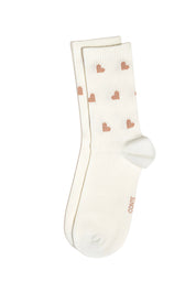 White socks with pink heart patterns on a white background #color_milk