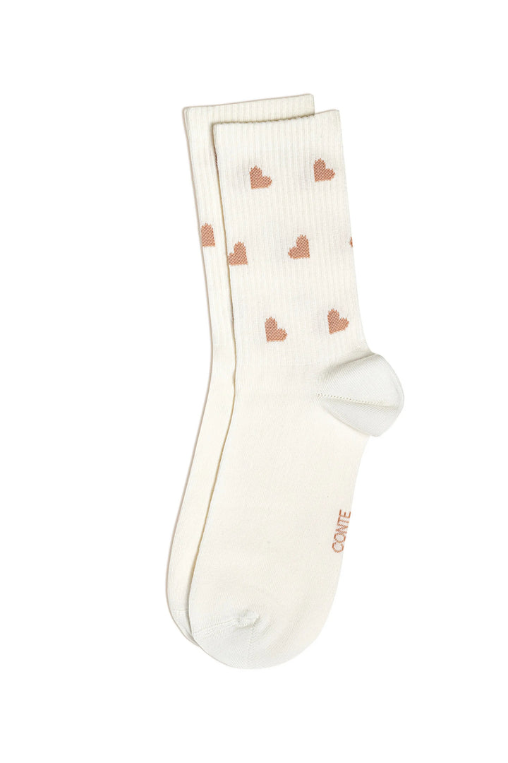 White socks with pink heart patterns on a white background #color_milk