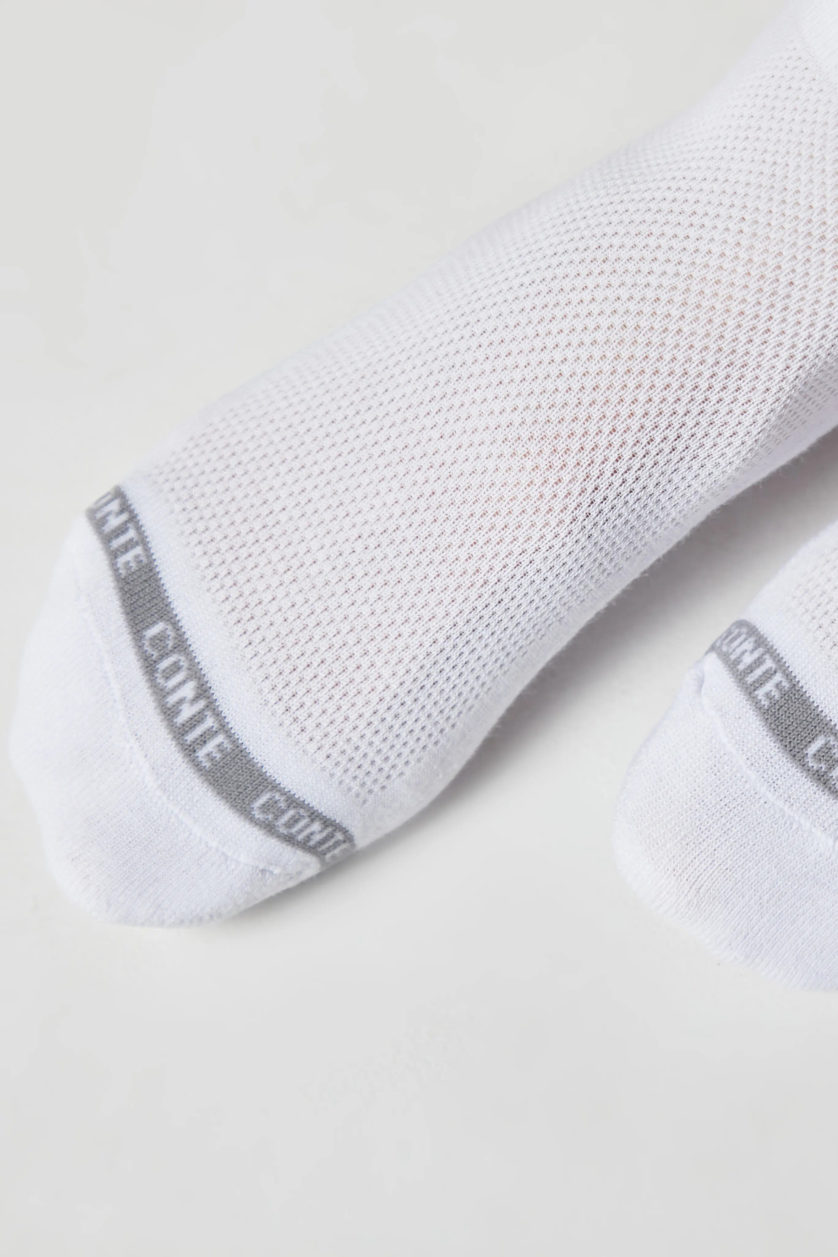 White socks with gray label on a light background #color_white