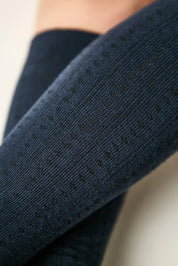 Close-up of dark blue fabric with small black specks on a light background #color_dark-blue