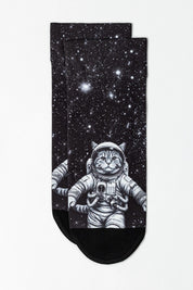 Pair of socks with an astronaut cat design on a starry background
