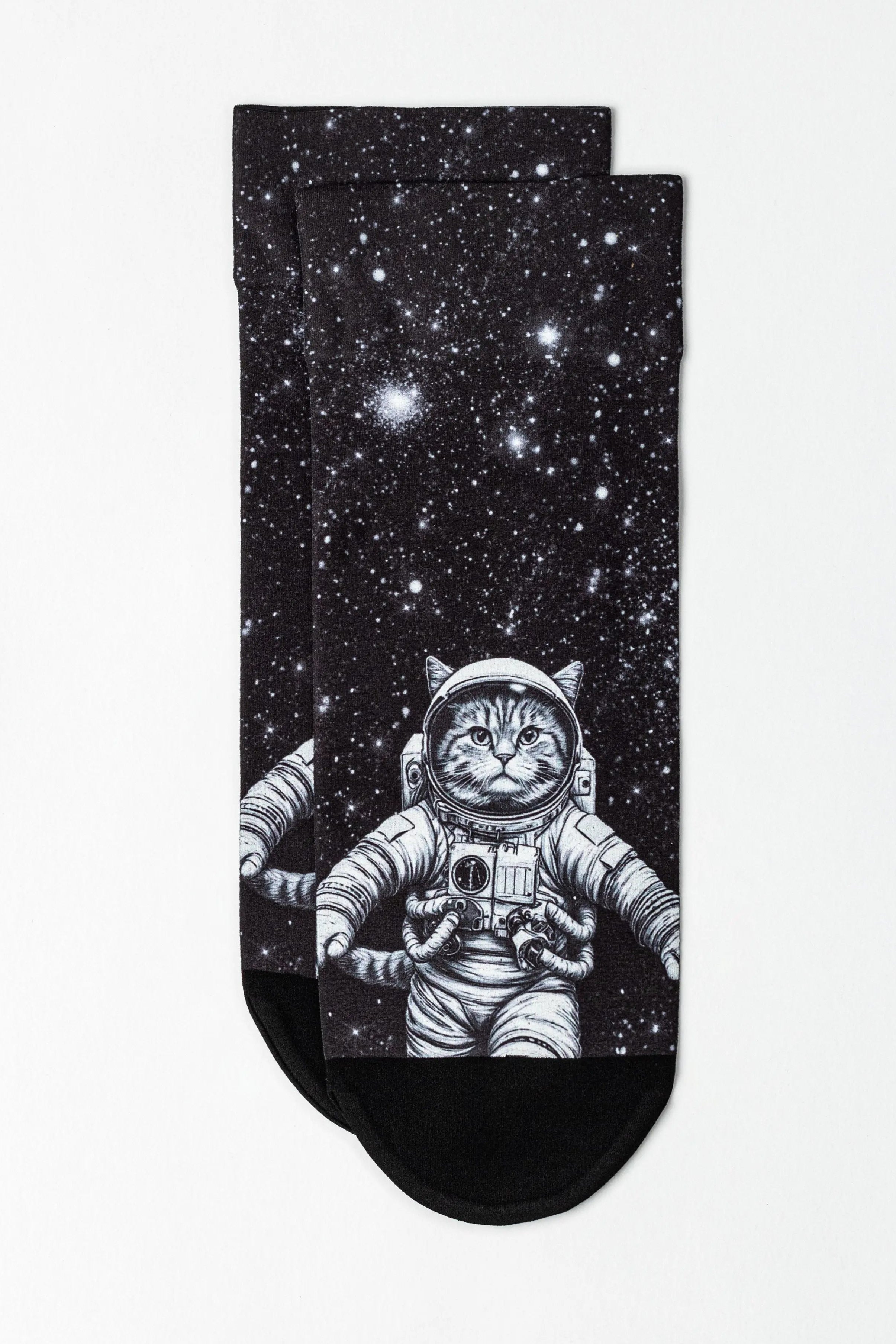 Pair of socks with an astronaut cat design on a starry background