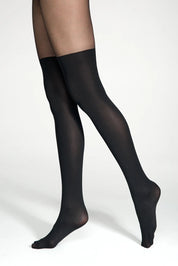 Black tights worn by a person on a white background #color_nero-black