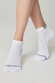 White ankle socks with gray accents worn by a person on a light gray background #color_white