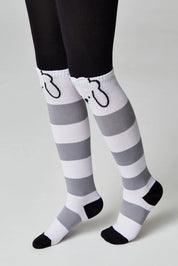 Gray and white striped socks with black toes and heels on a plain background