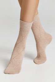 Beige patterned socks worn by a person on a light gray background #color_beige