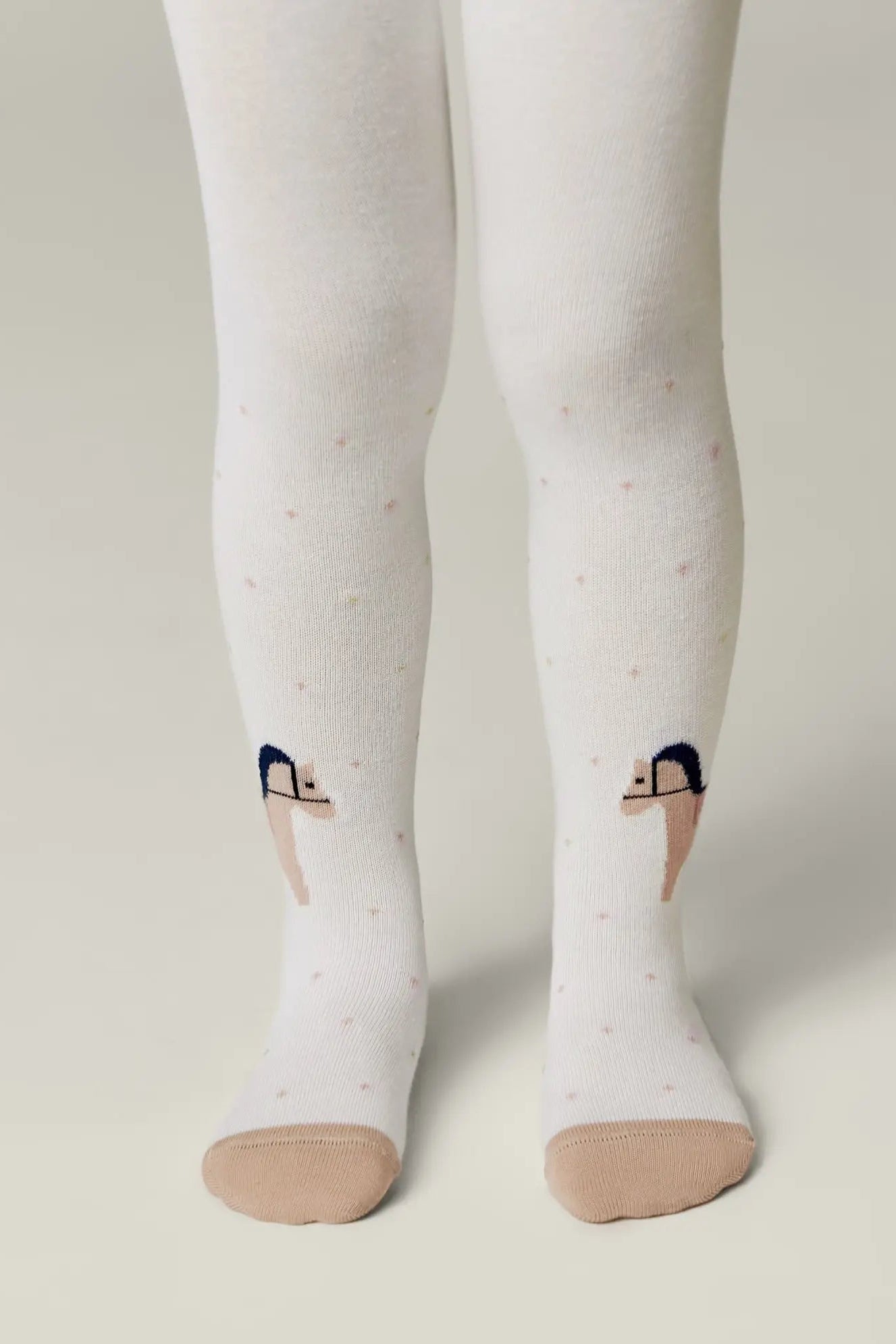 White tights with black ballet dancer design socks on a neutral background #color_milky