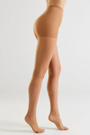 Side view of a model's legs wearing sheer nude hosiery against a clean light gray studio background.