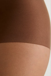 Close-up of a hosiery leg band in a medium warm brown color, shown on a model's leg against a light neutral background.