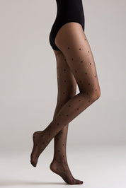 Brown polka dot tights worn by a person on a plain background #color_grafit