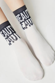 White socks with black text on a light gray background
