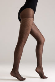 Brown patterned tights worn by a person on a plain background #color_grafit