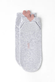 A pair of light heather gray ankle socks with a small pink heart detail at the top cuff and vertical pink 'COOIE' branding on the sole, shown on a clean white background.