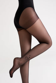 Black bodysuit and sheer brown tights on a plain background