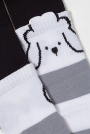 Pair of socks with a dog design on a black, white, and gray background