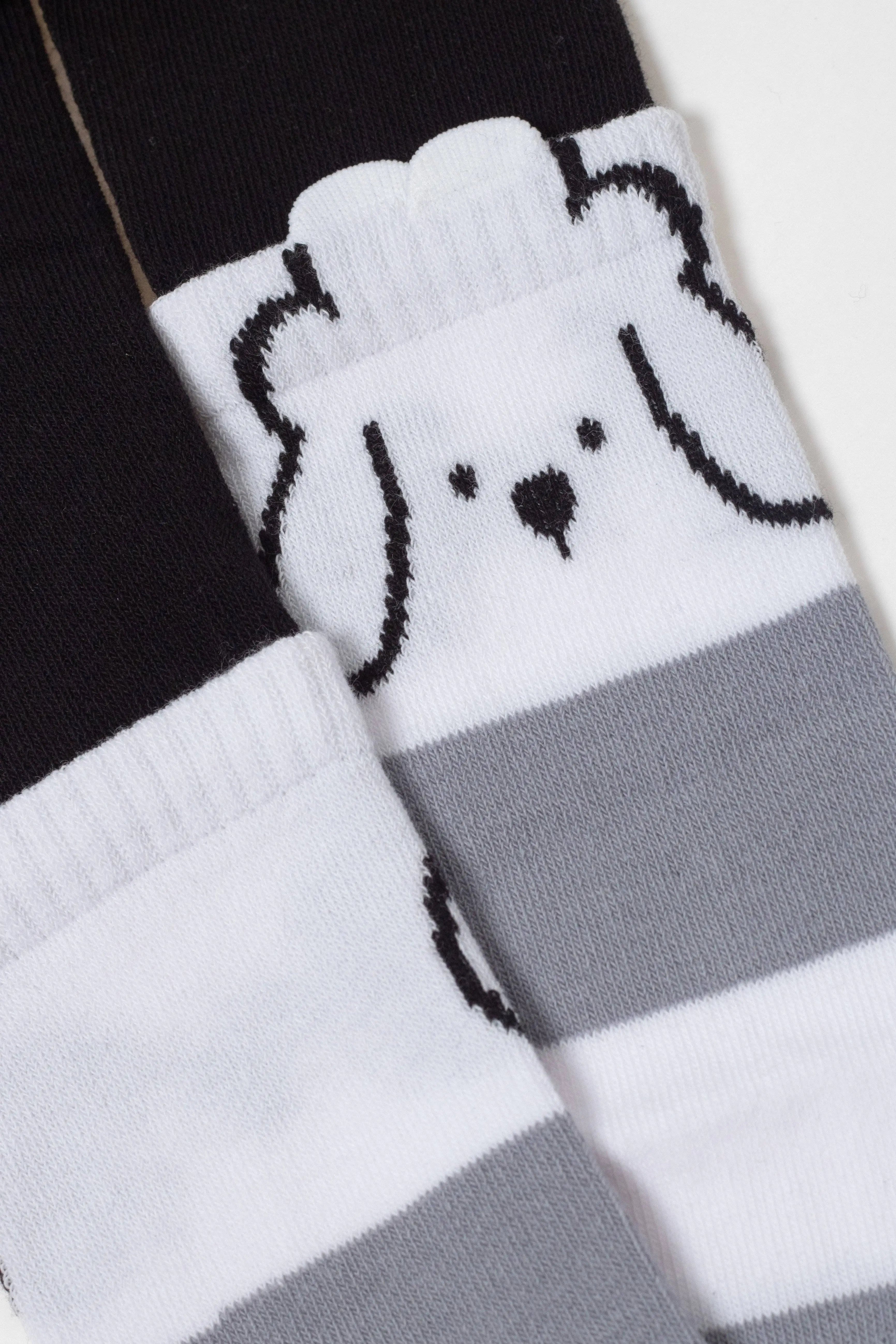 Pair of socks with a dog design on a black, white, and gray background