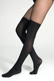 Black sheer stockings worn by a person on a white background #color_nero-black