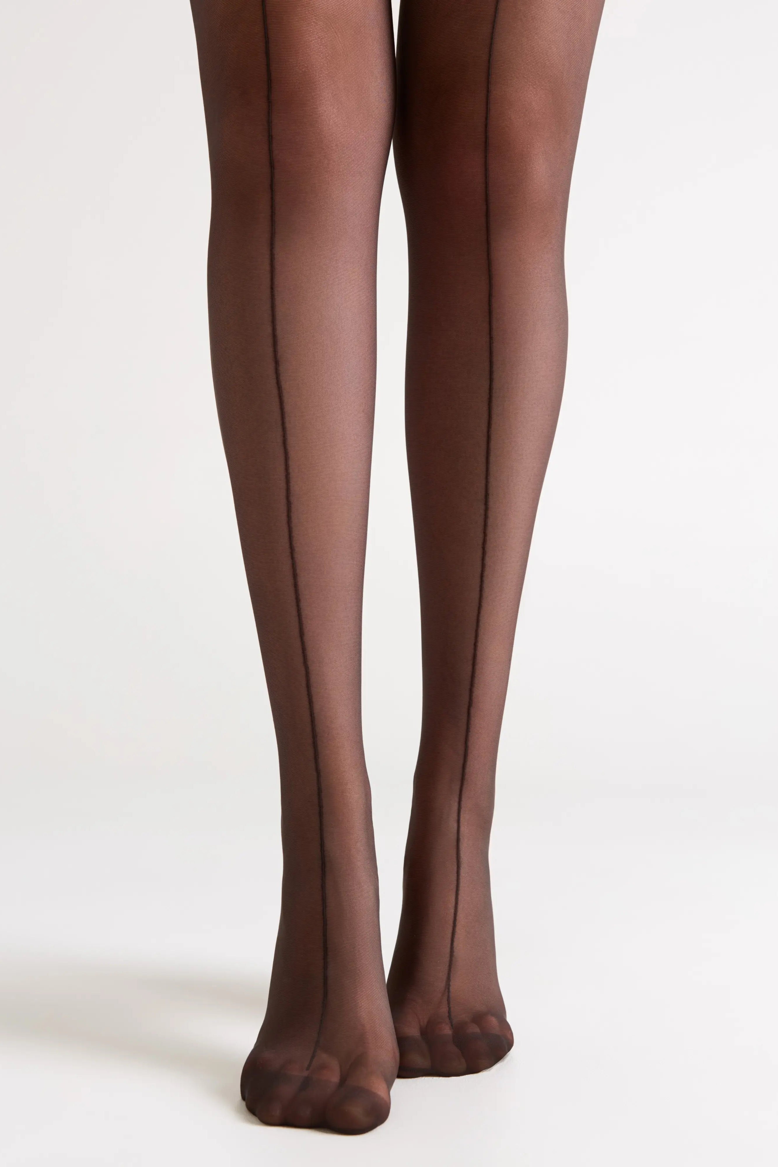 Dark brown tights worn by a person on a white background