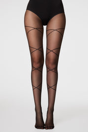 Black fishnet stockings with crisscross design worn by a person on a white background