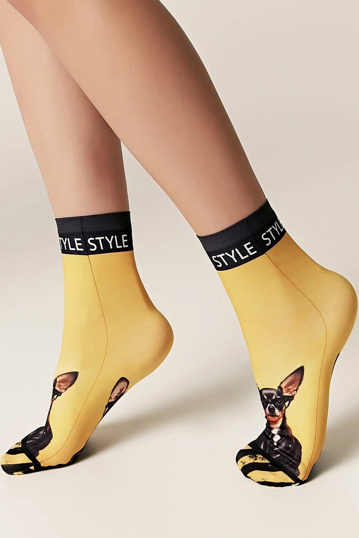 Yellow socks with dog design and 'STYLE' text on a beige background