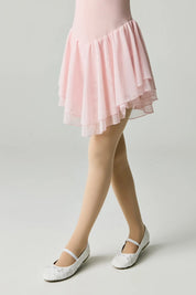 Person wearing a pink skirt and white shoes on a plain background #color_natural-nude