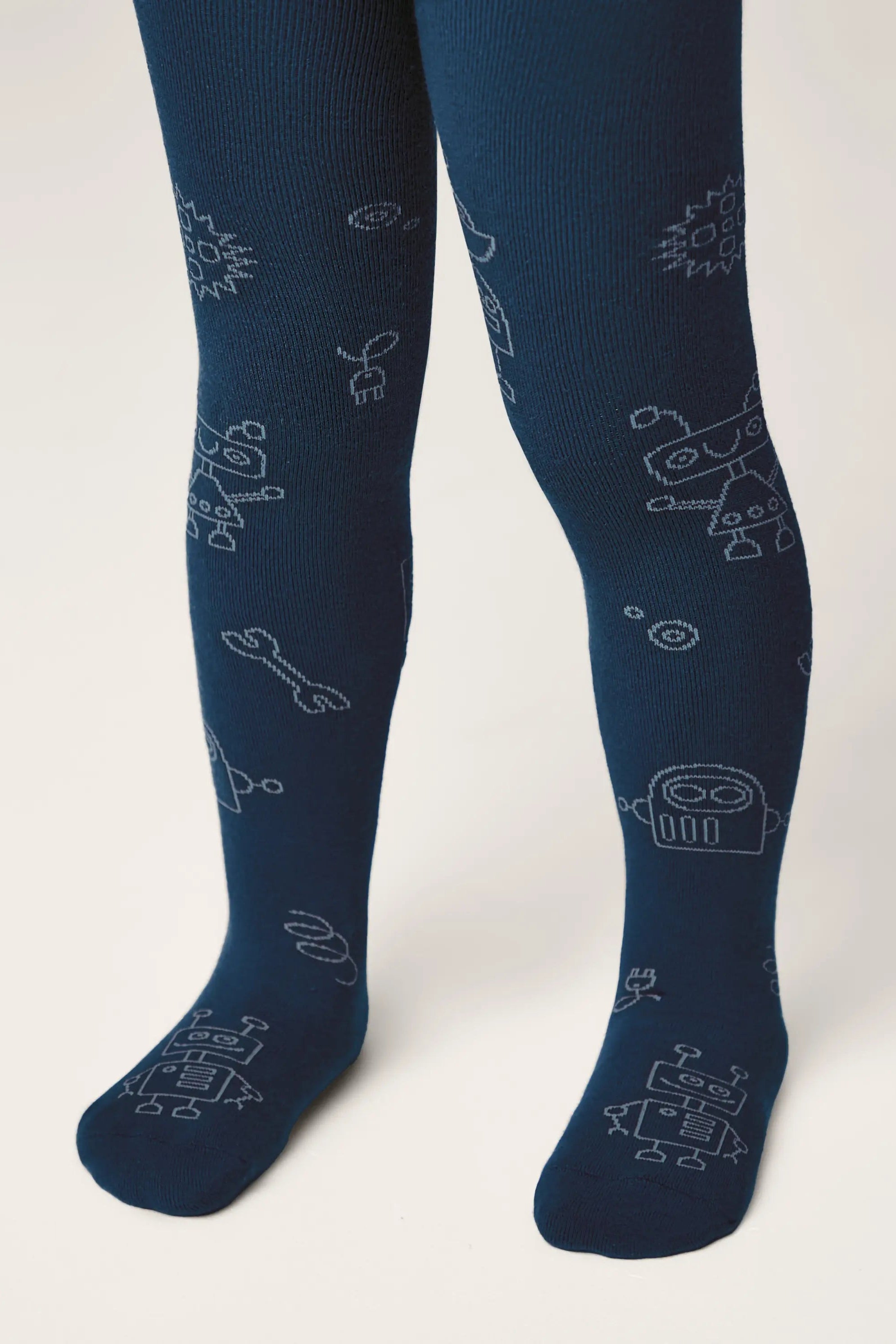 Navy blue tights with robot pattern worn by a person on a white background #color_dark-blue