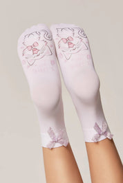 White knee-high socks with pink floral designs on a neutral background