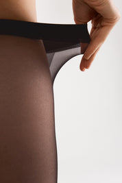 Person wearing sheer black stockings with a white background #color_grafit