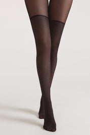 Black tights worn by a person on a light gray background #color_grafit