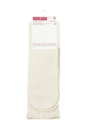 Pair of beige socks with a label on a white background