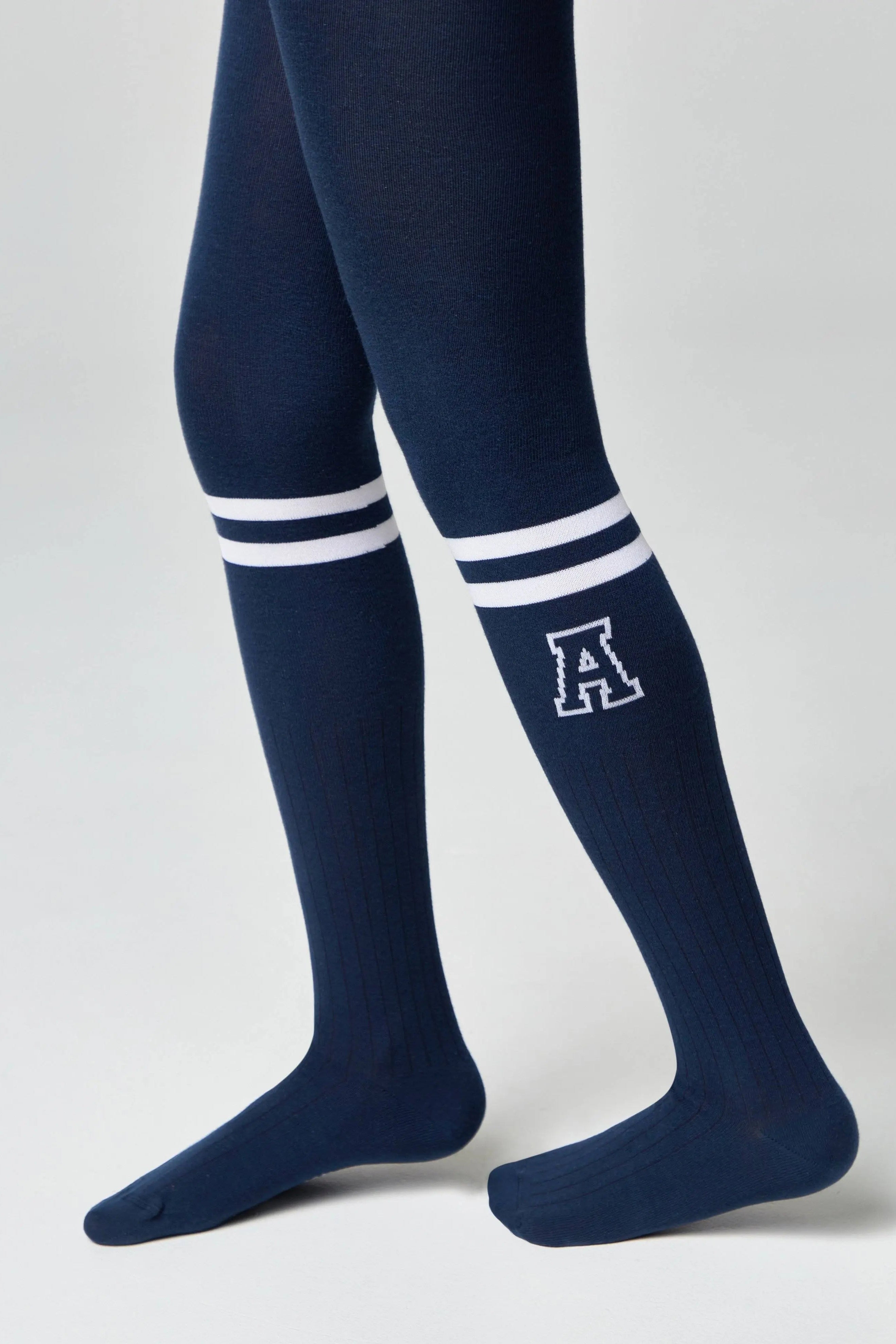 Navy knee-high socks with white stripes and a letter 'A' on a light gray background