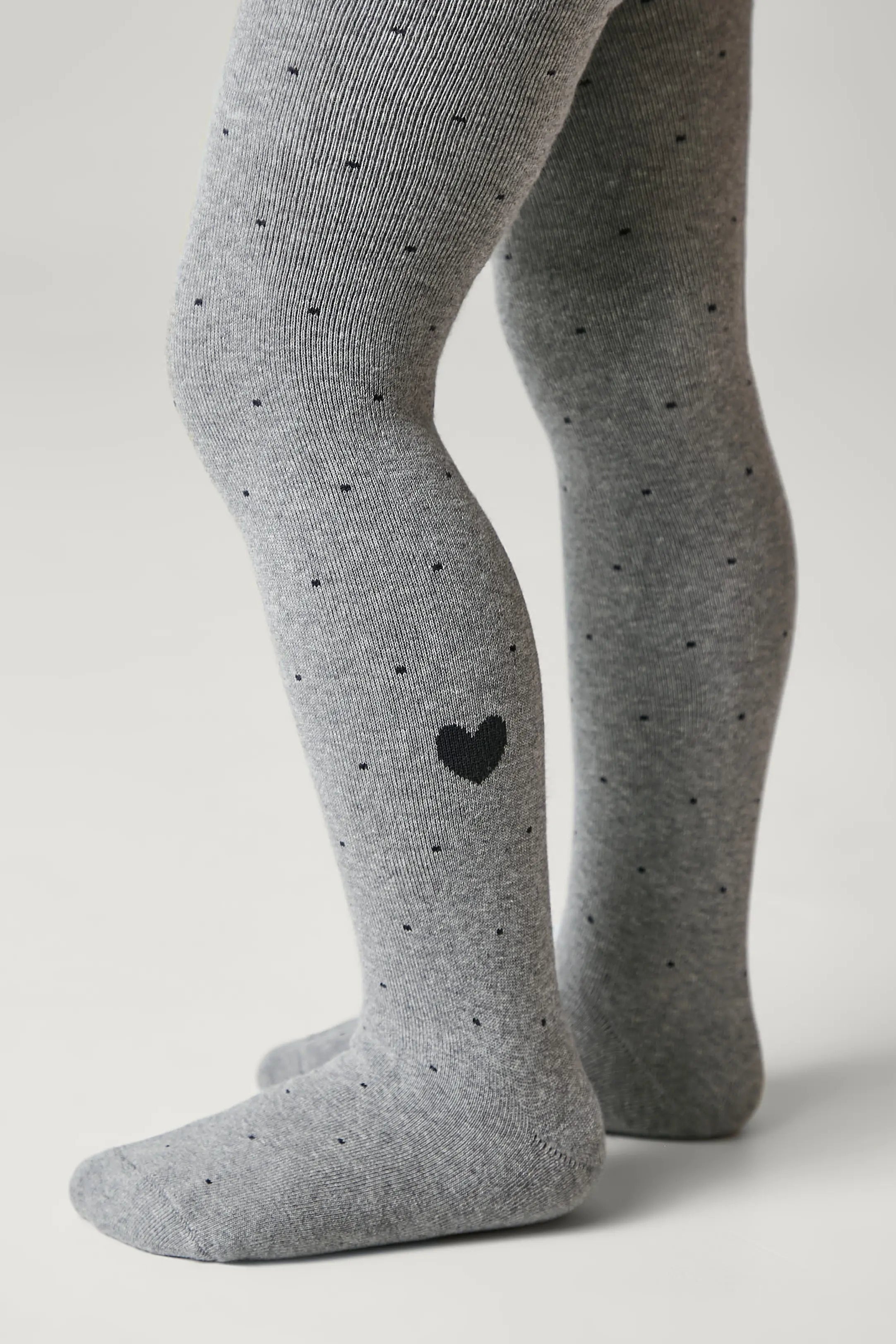 Gray tights with black heart design on a neutral background #color_gray