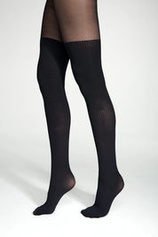 Black knee-high socks worn by a person on a white background