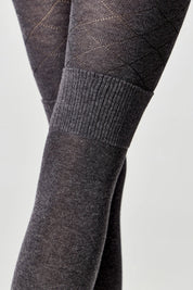 Close-up of dark gray tights with a subtle pattern on a light gray background #color_dark-gray