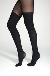 Black knee-high socks worn on a white background