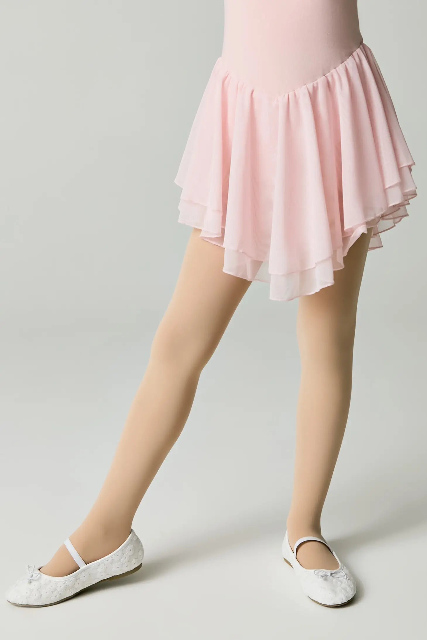 Person wearing a pink skirt on a plain background #color_natural-nude