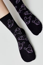 Black socks with white bunny designs on a light gray background