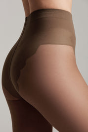 Brown tights worn by a person on a plain background