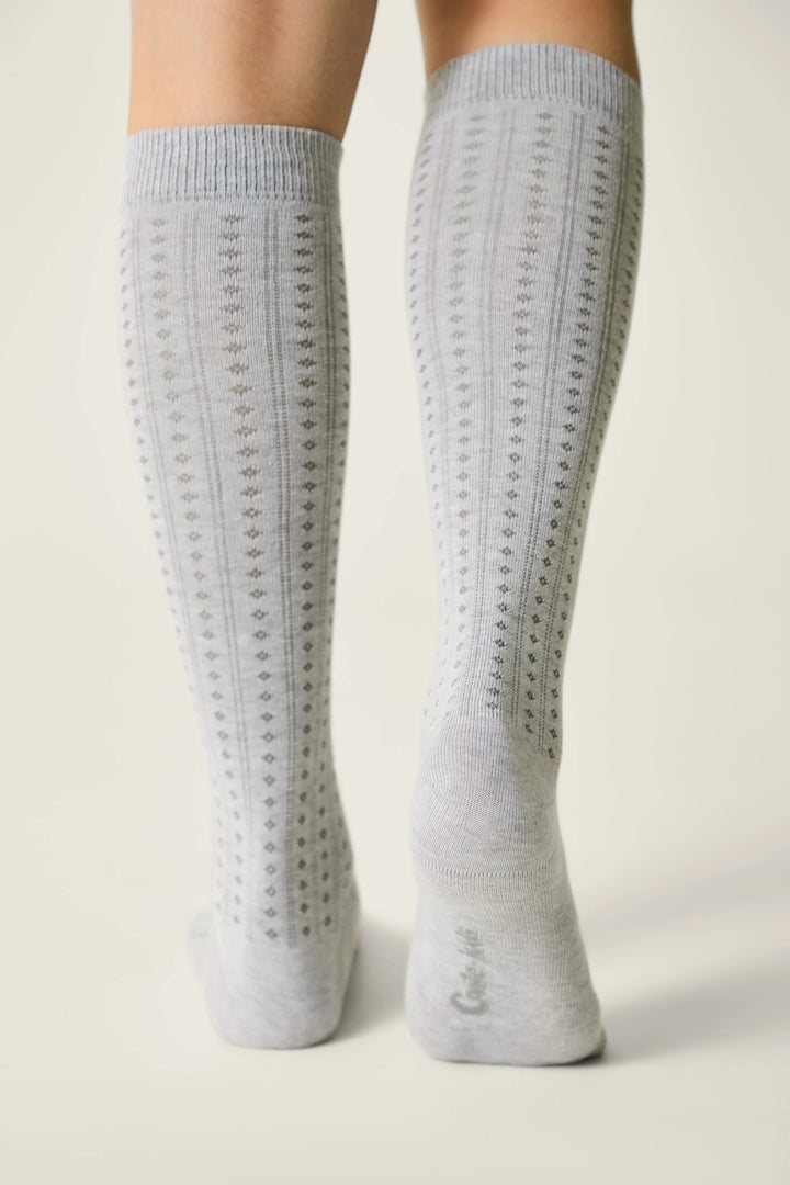 Gray knee-high socks with a textured pattern on a light background #color_light-gray