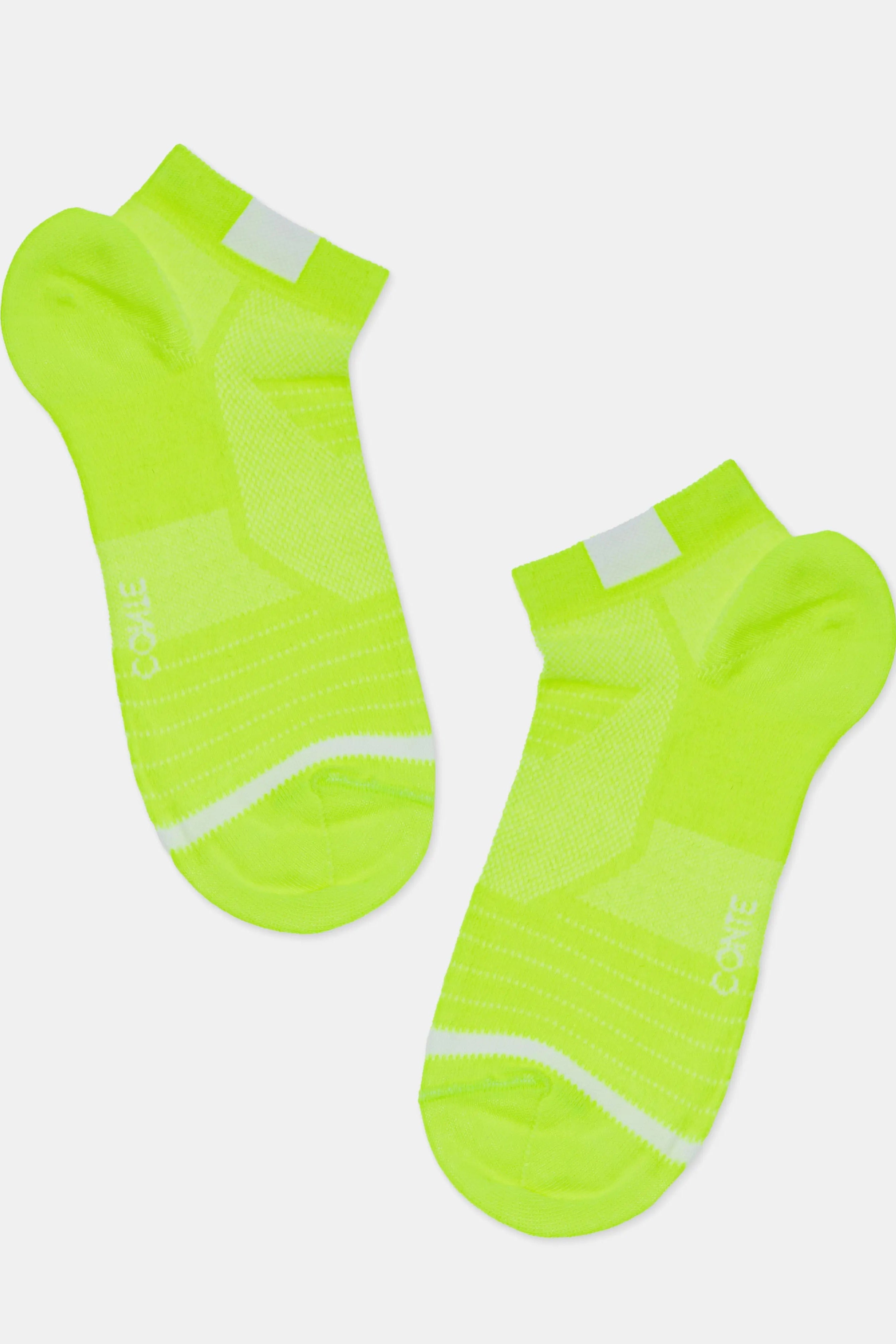 Pair of neon green socks with white accents on a light gray background #color_lime-green