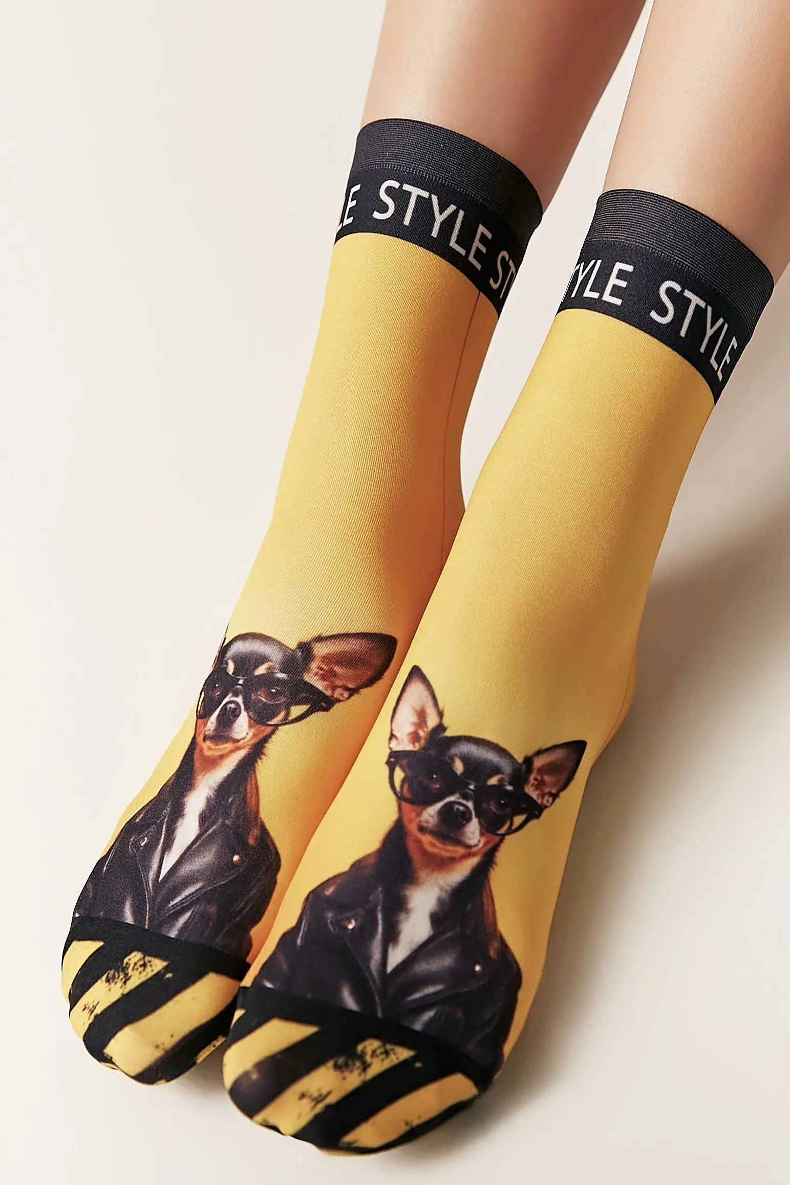 Yellow socks with dog print and 'Style' text on a light background