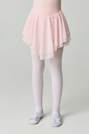 Person wearing a pink skirt and tights on a plain background #color_bianco